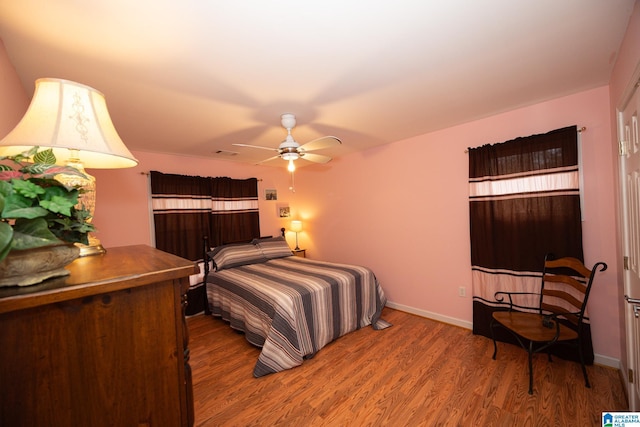 bedroom featuring hardwood / wood-style floors and ceiling fan