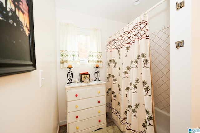 bathroom with shower / tub combo with curtain