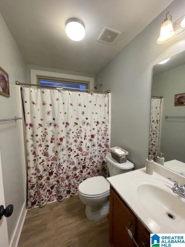 bathroom featuring vanity, curtained shower, toilet, and wood-type flooring