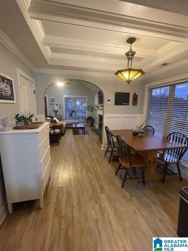 dining room with wood-type flooring and ornamental molding