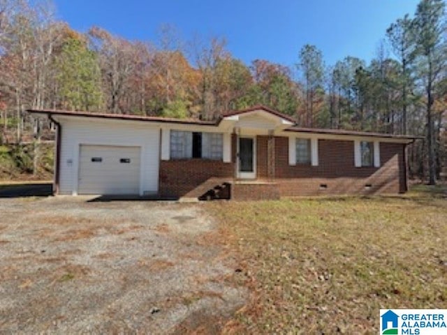 single story home featuring a garage and a front lawn