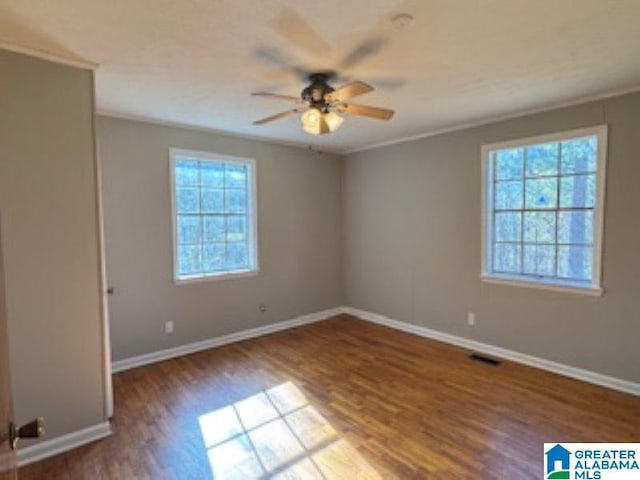 spare room featuring hardwood / wood-style flooring, ceiling fan, and a healthy amount of sunlight