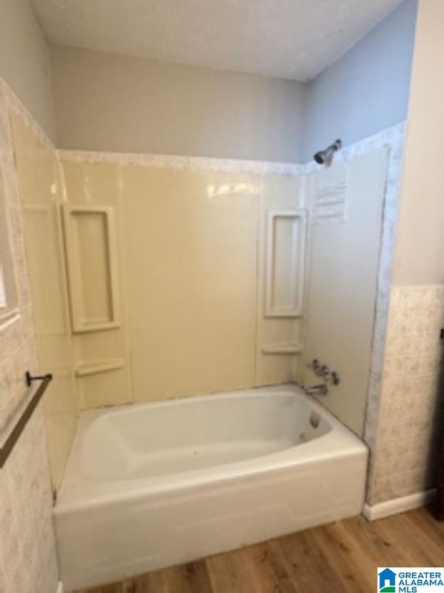 bathroom featuring bathtub / shower combination and hardwood / wood-style floors