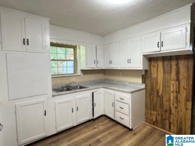 kitchen featuring sink, white cabinets, and dark hardwood / wood-style floors