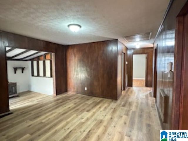 interior space with light wood-type flooring and wooden walls