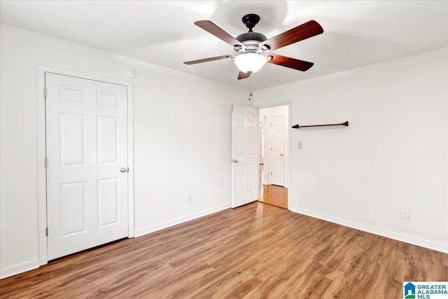 unfurnished bedroom featuring light wood-type flooring and ceiling fan