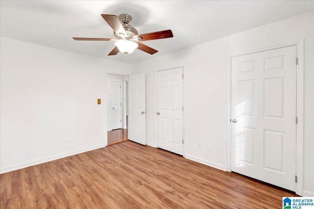 unfurnished bedroom featuring ceiling fan and light wood-type flooring