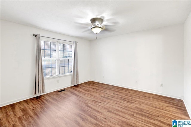 unfurnished room with hardwood / wood-style flooring, ceiling fan, and a textured ceiling