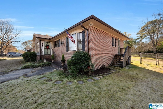 view of home's exterior with a yard