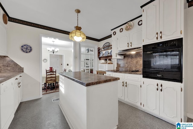 kitchen featuring decorative backsplash, white cabinetry, a center island, and black appliances