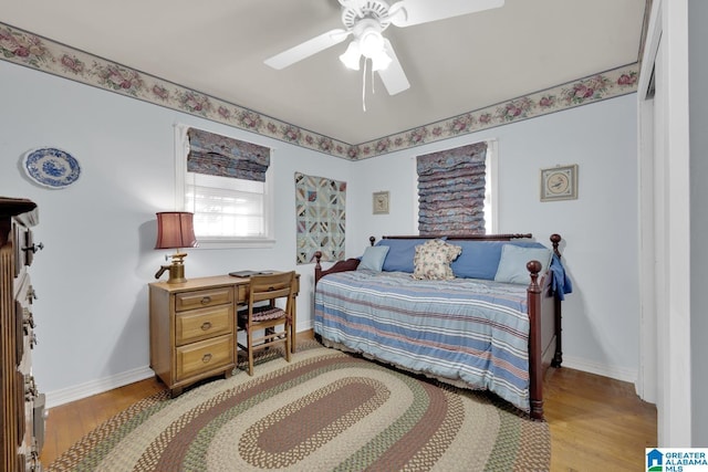 bedroom with ceiling fan and light hardwood / wood-style floors