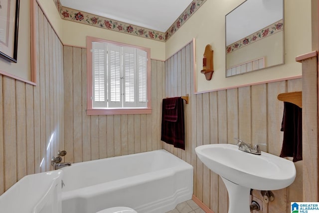 bathroom featuring a tub to relax in and sink