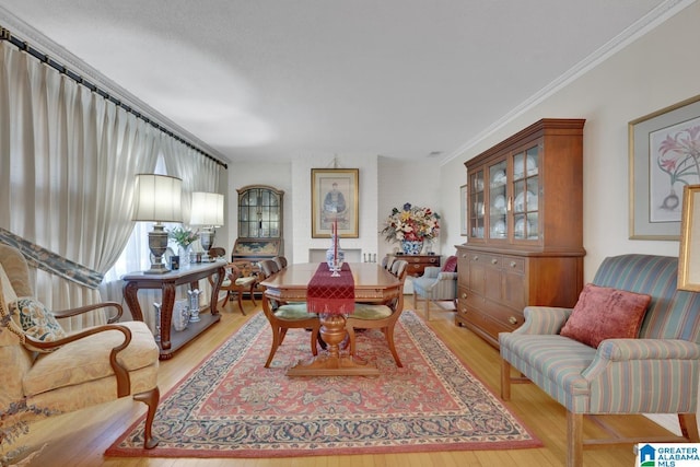 dining area featuring light hardwood / wood-style floors and crown molding