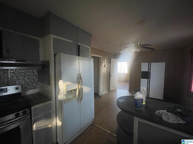 kitchen featuring exhaust hood, electric stove, ceiling fan, dark hardwood / wood-style floors, and white fridge with ice dispenser