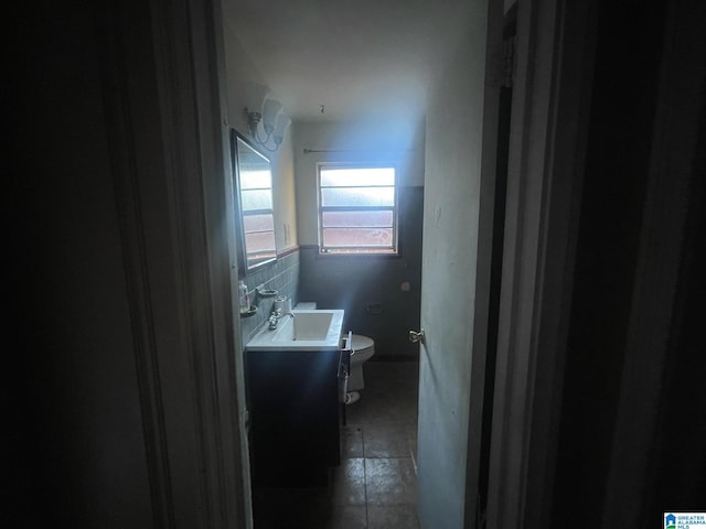 bathroom featuring tile patterned flooring, vanity, and toilet