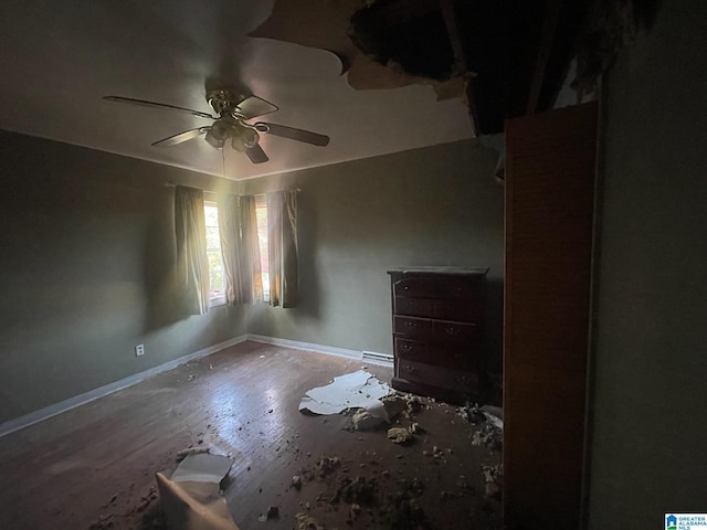 unfurnished bedroom with ceiling fan and wood-type flooring