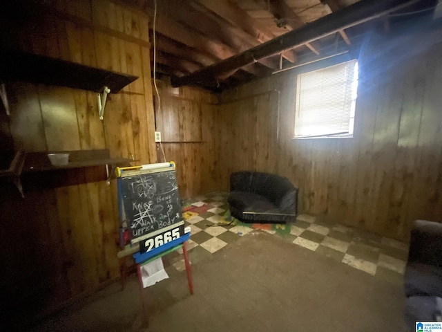 basement featuring wood walls