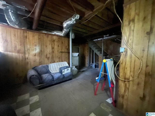 basement featuring wood walls