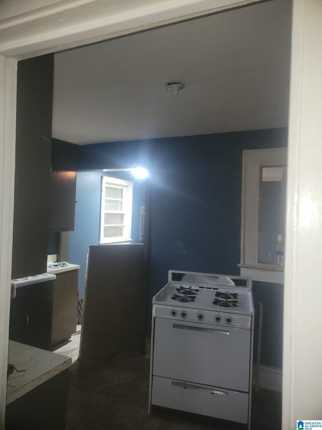 kitchen featuring dark tile patterned floors and white range