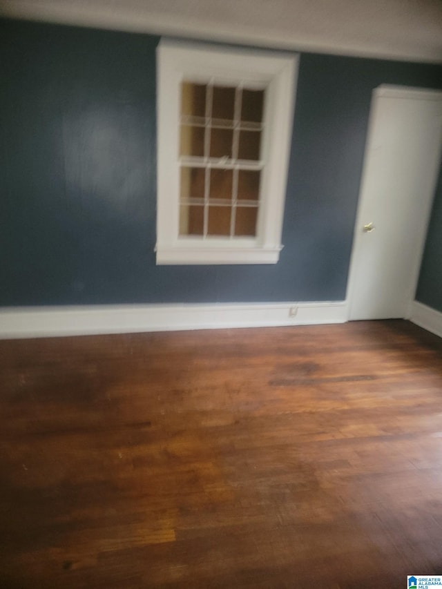 unfurnished room with hardwood / wood-style floors