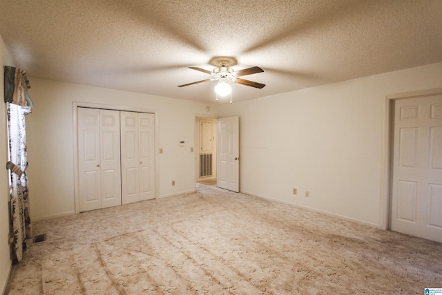 unfurnished bedroom with ceiling fan, a closet, carpet, and a textured ceiling