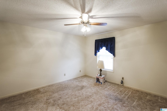 carpeted empty room featuring ceiling fan and a textured ceiling