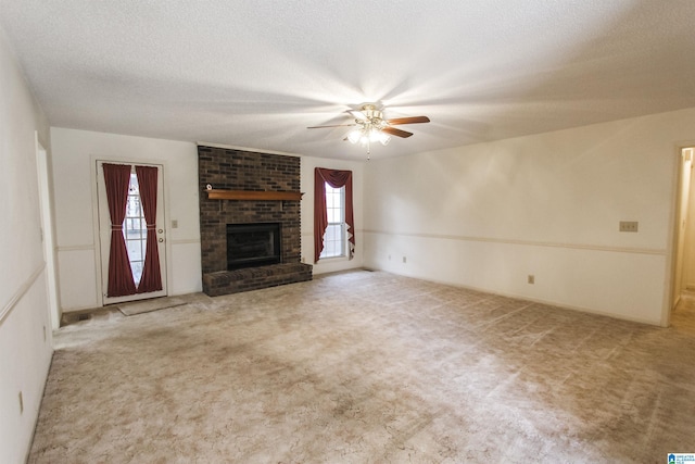 unfurnished living room featuring a wealth of natural light, ceiling fan, and light colored carpet