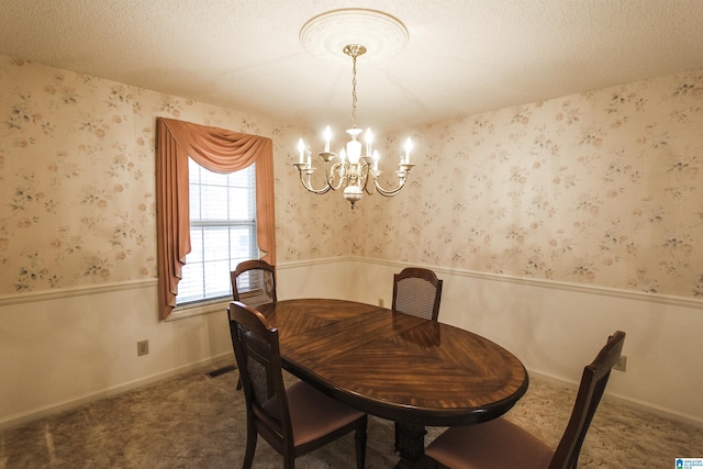 dining room featuring a textured ceiling and a notable chandelier