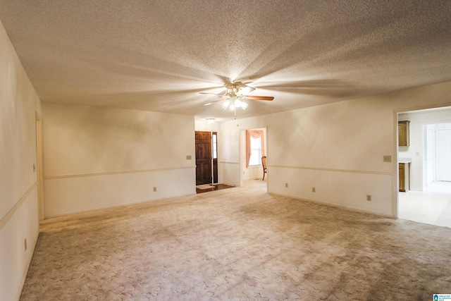 spare room with ceiling fan, carpet, and a textured ceiling