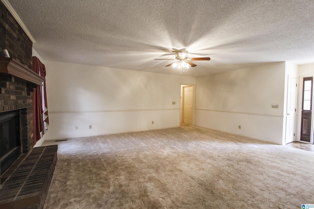 unfurnished living room with a textured ceiling, ceiling fan, carpet floors, and a fireplace