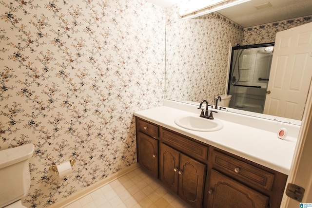 bathroom with vanity, toilet, and an enclosed shower