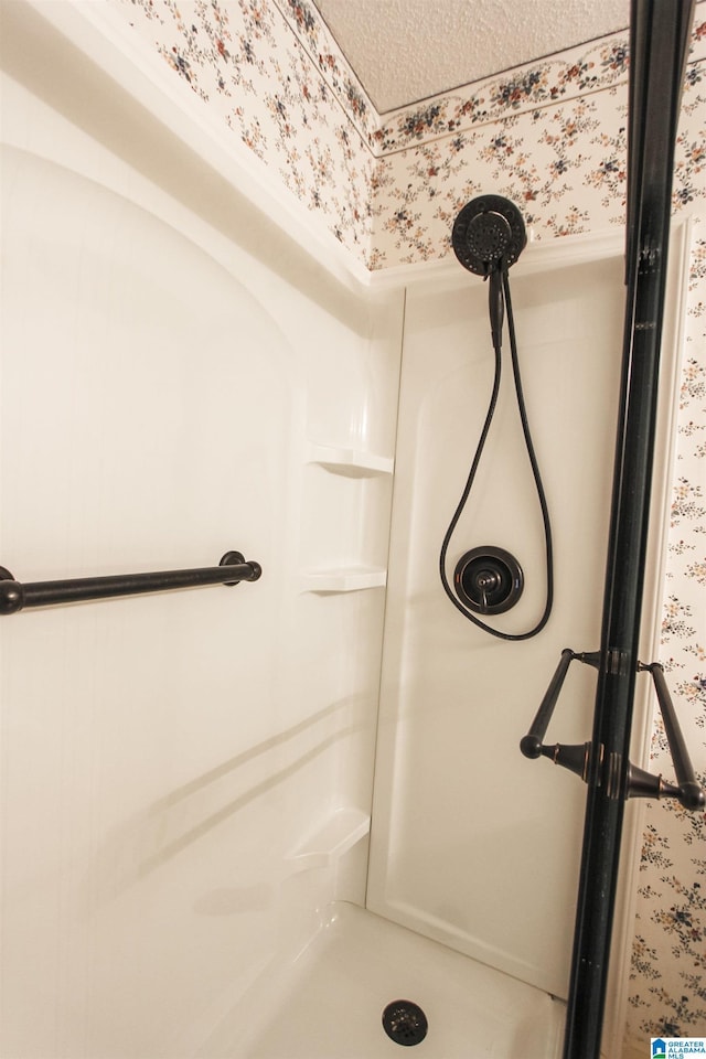 bathroom featuring a shower and a textured ceiling