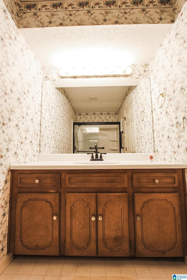 bathroom with tile patterned flooring and vanity