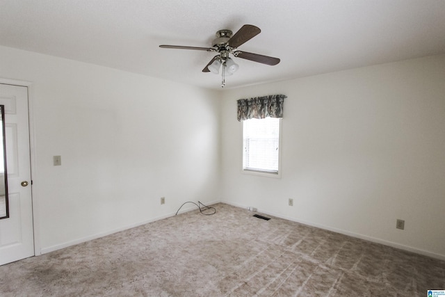 carpeted spare room featuring ceiling fan