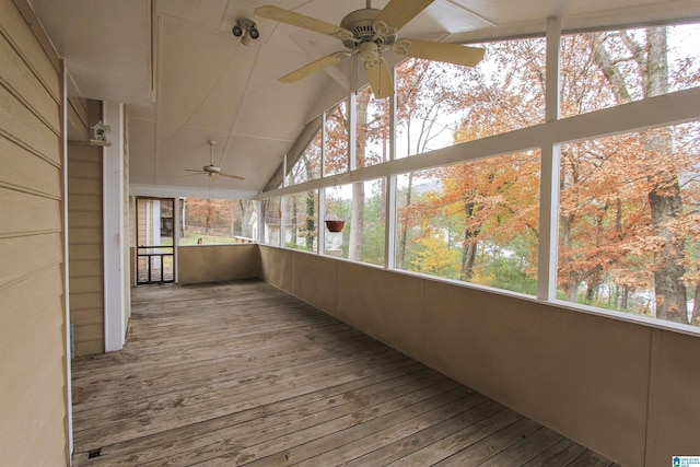 unfurnished sunroom with ceiling fan and vaulted ceiling