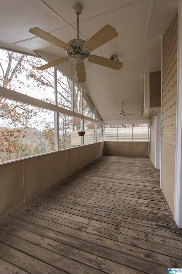 unfurnished sunroom with ceiling fan