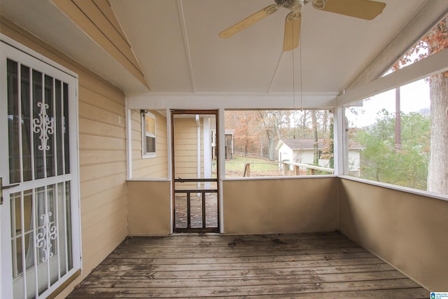 unfurnished sunroom with ceiling fan and vaulted ceiling