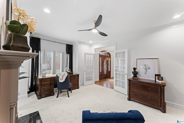 office with ceiling fan, crown molding, light carpet, and french doors