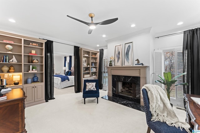 office with crown molding, a fireplace, ceiling fan, and light colored carpet