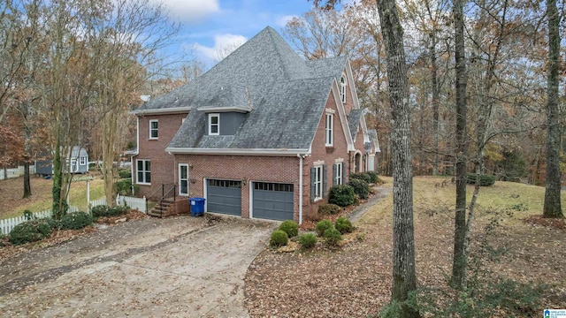 view of property exterior with a garage, driveway, brick siding, and roof with shingles