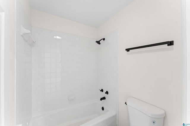 bathroom featuring toilet and tiled shower / bath