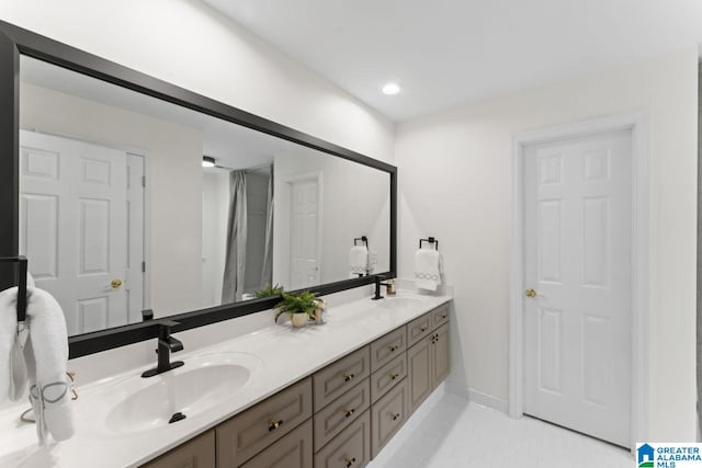 bathroom with tile patterned flooring and vanity