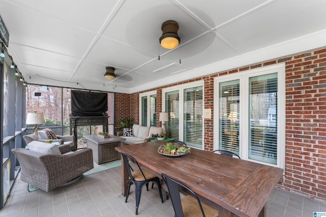 sunroom / solarium featuring ceiling fan