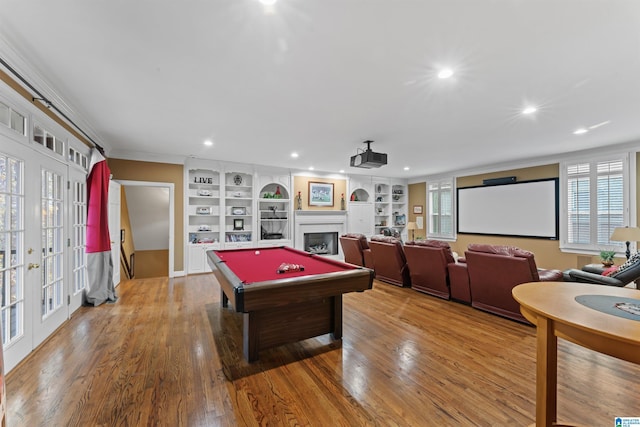 rec room with french doors, built in features, light hardwood / wood-style flooring, ornamental molding, and pool table