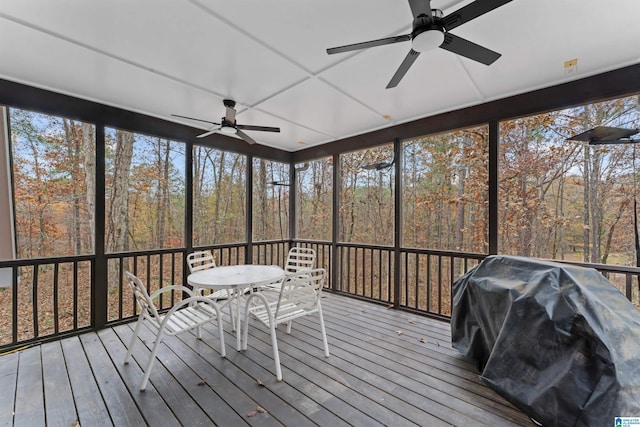 unfurnished sunroom featuring ceiling fan