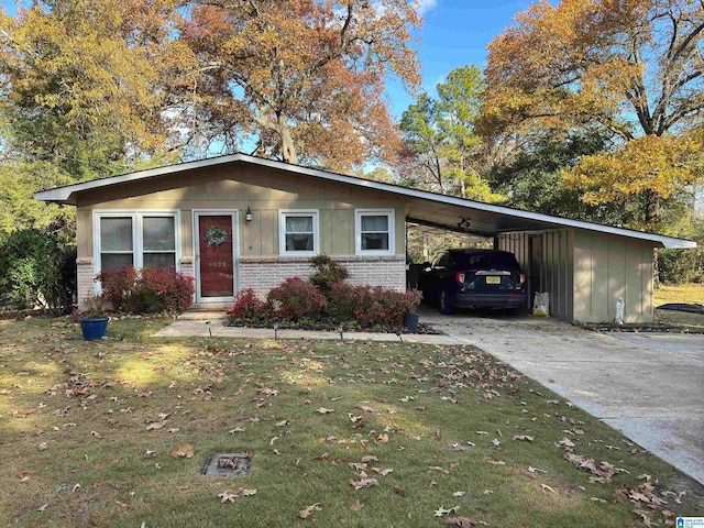 ranch-style house with a carport and a front lawn