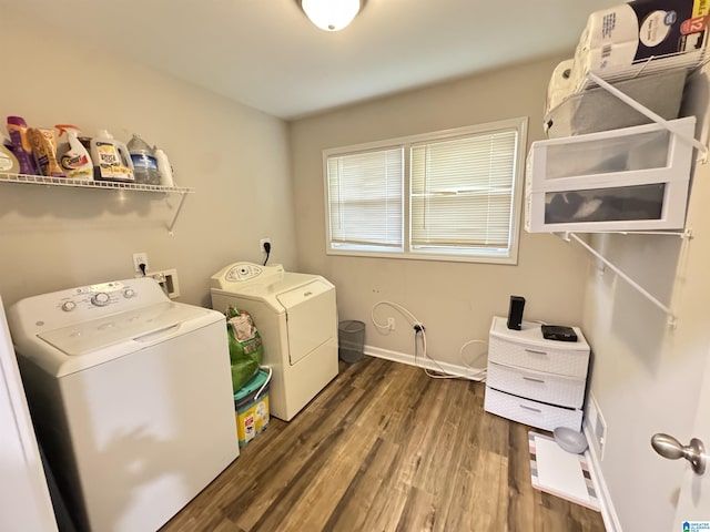 washroom with washer and dryer and dark wood-type flooring