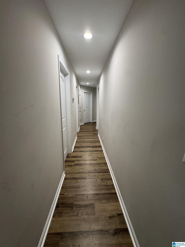 hall with dark hardwood / wood-style flooring