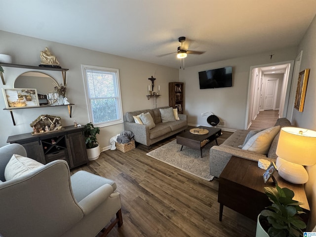 living room with ceiling fan and dark hardwood / wood-style flooring