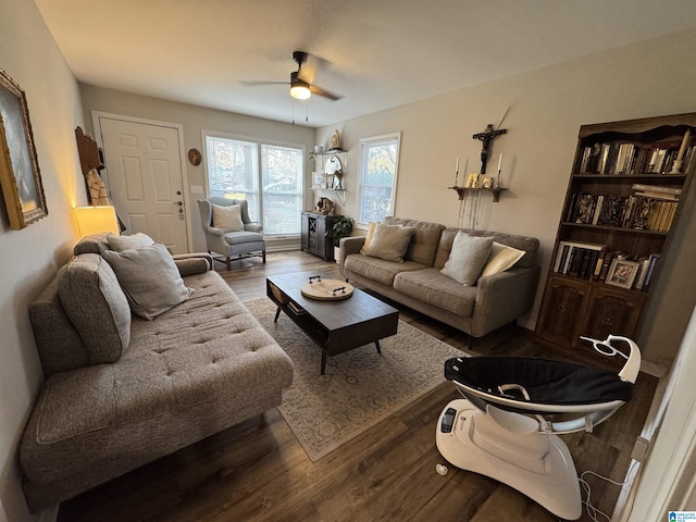 living room featuring hardwood / wood-style floors and ceiling fan